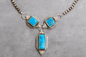 Gary Glandon Turquoise Necklace on a Gray Background