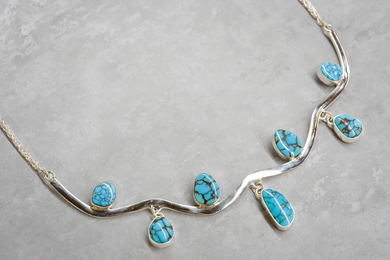 Necklace with turquoise stones on a white background