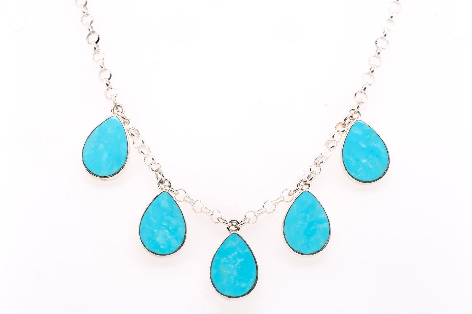 A silver chain necklace featuring five teardrop-shaped turquoise set in silver, displayed against a plain white background.