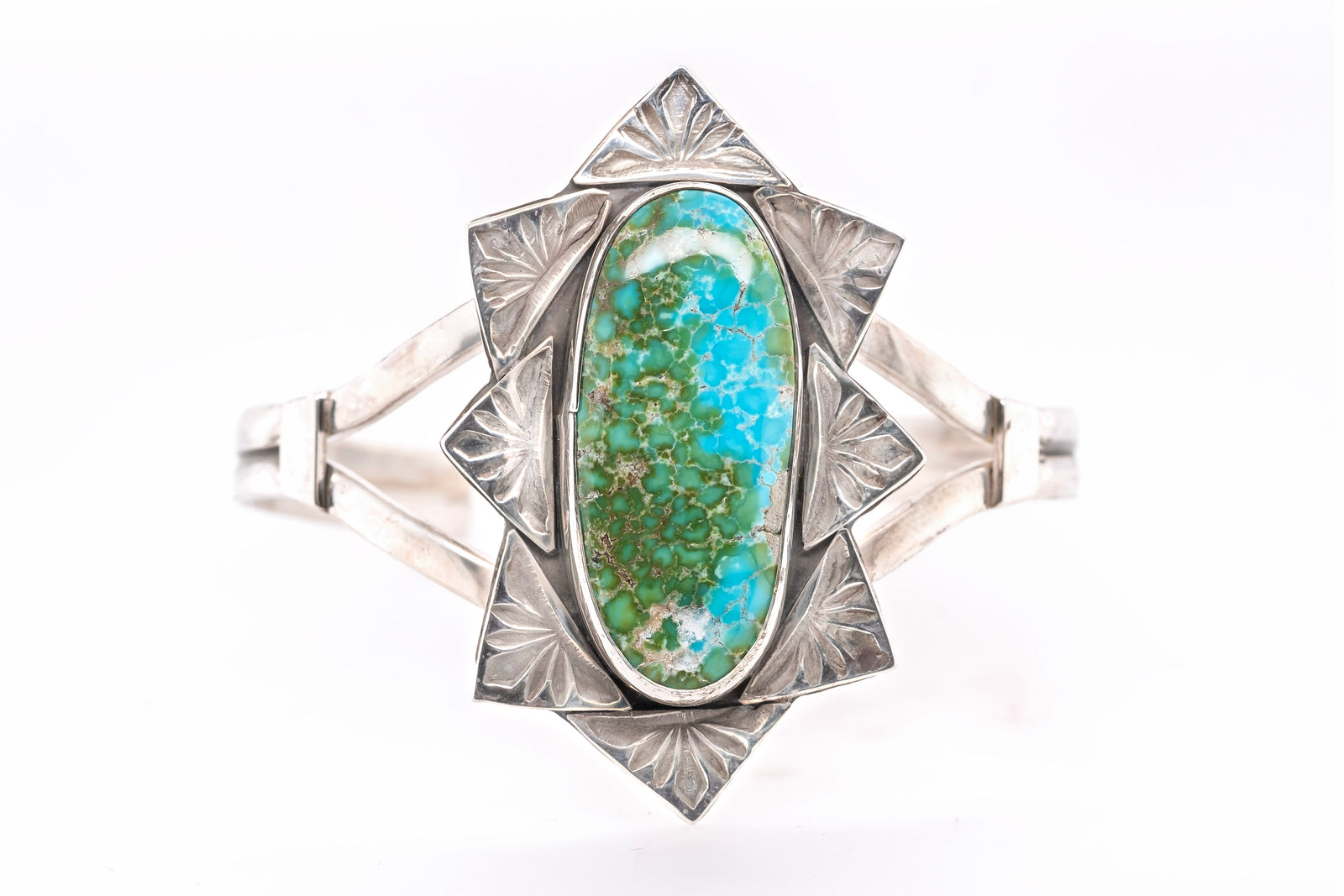 A sterling silver cuff bracelet featuring a large, oval-shaped turquoise stone with green and blue matrix patterns, set against a clean white background.