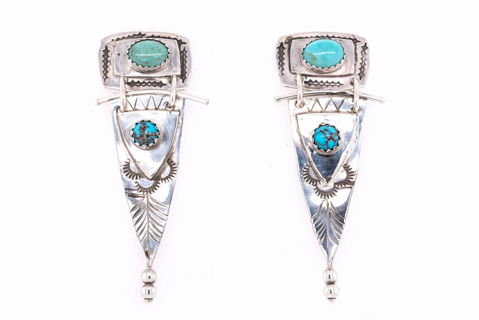 A pair of silver dangle earrings featuring turquoise stones, set against a plain white background.