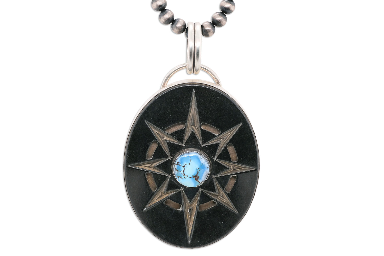Handmade Golden Hills Turquoise pendant by Skylar Glandon with carved Richlite compass design, silver bezel, and large bail for Navajo Pearls