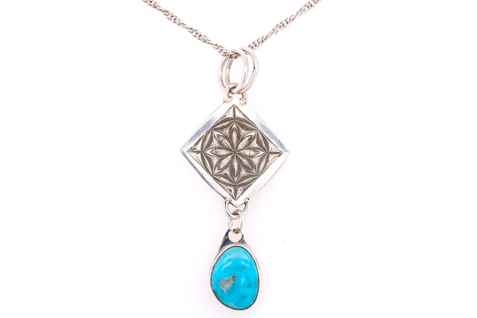 Handmade pendant with starburst stamped design and dangling turquoise stone by Gary Glandon