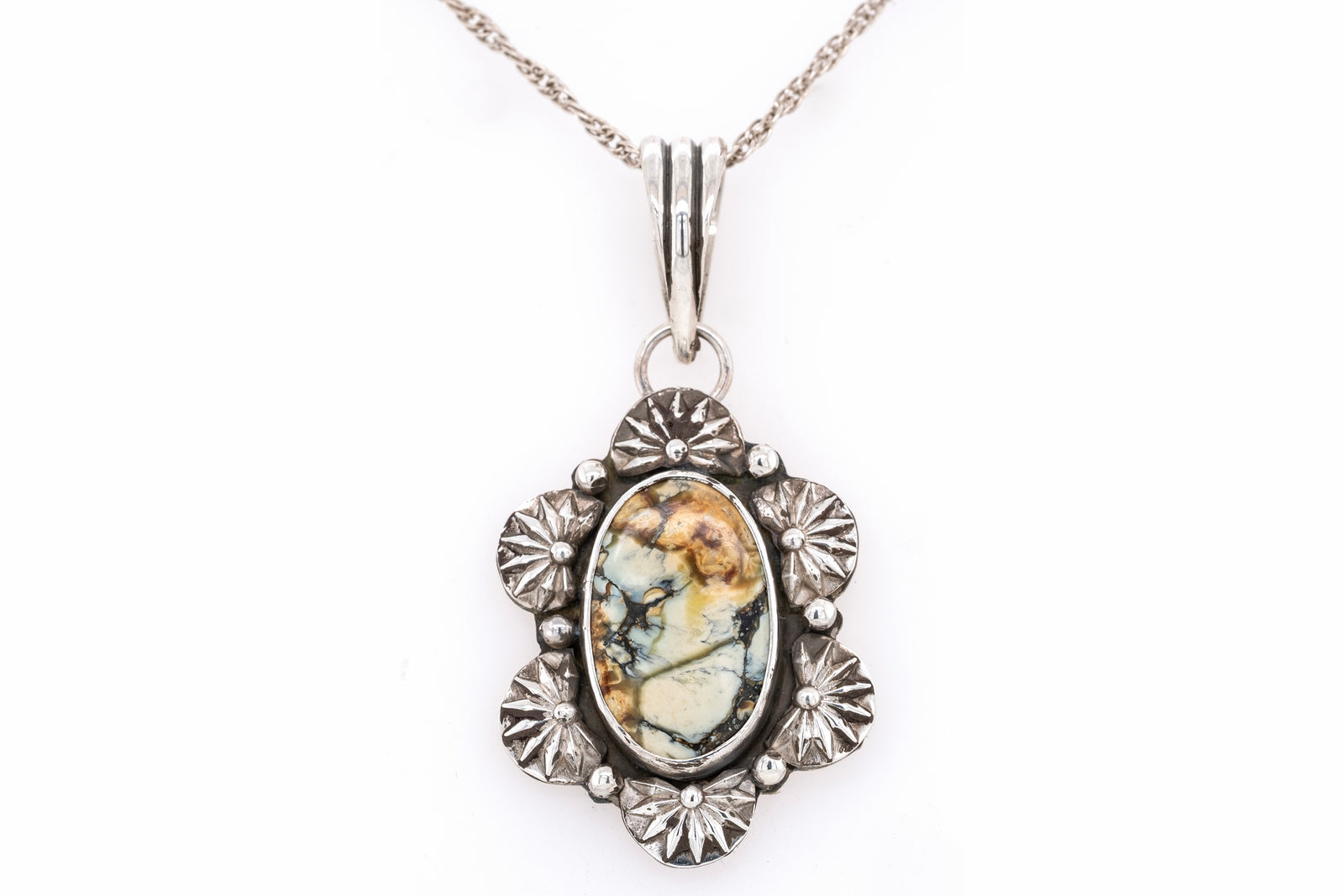 Brown New Lander stone and silver pendant with white background