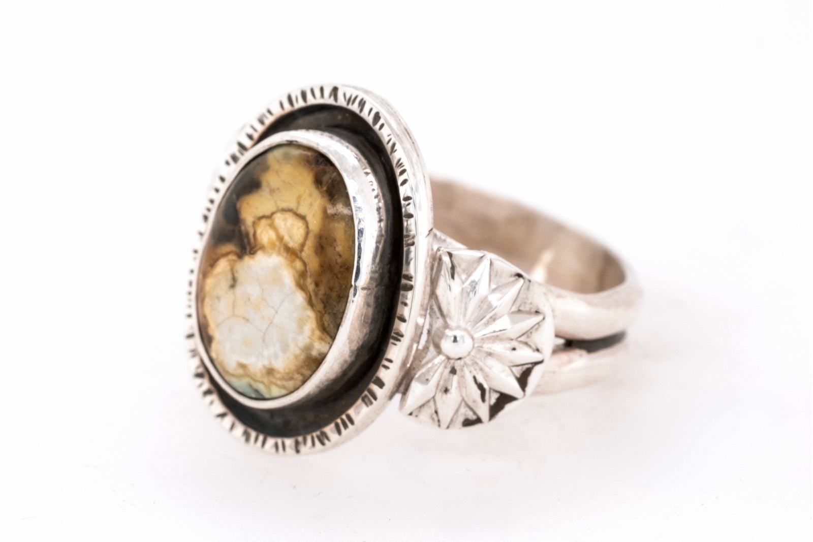 Silver ring with a New Lander stone on a white background
