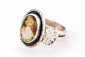 Silver ring with a New Lander stone on a white background