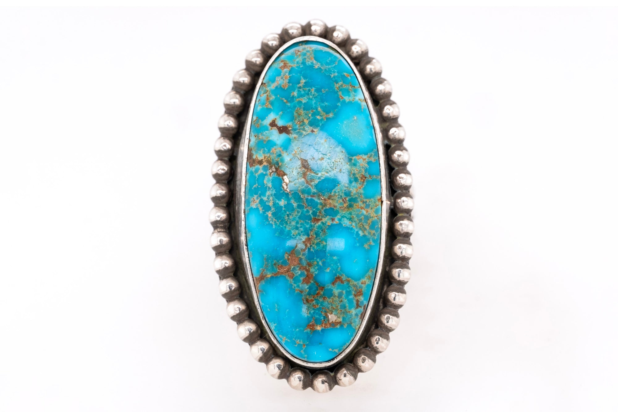 Turquoise ring with silver band on a white background