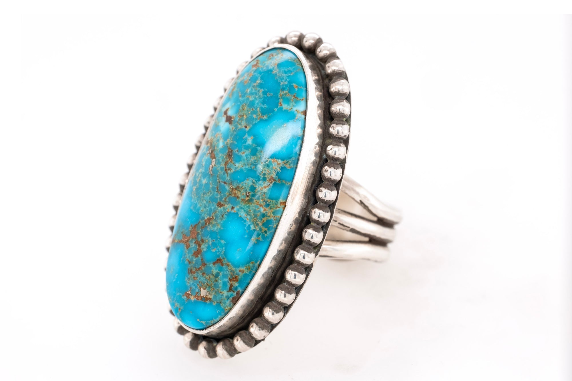 Turquoise ring with silver band on a white background