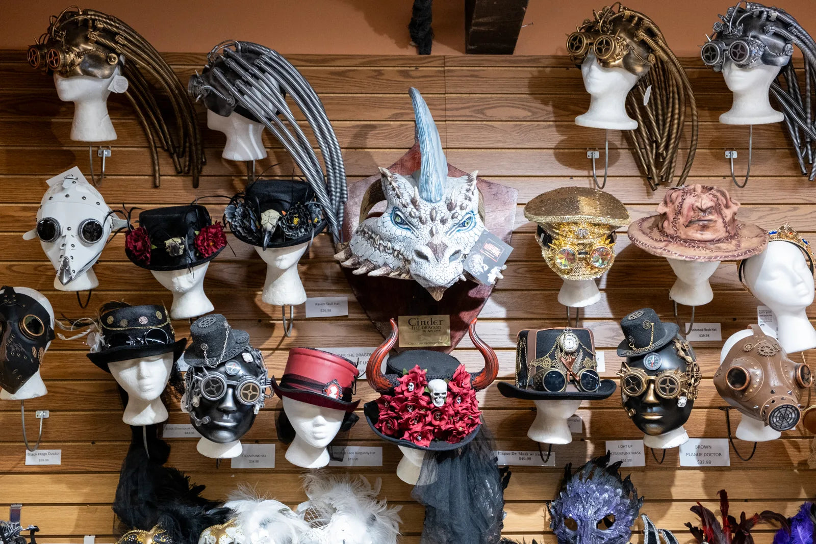 Steampunk hats, masks, and costume accessories on display